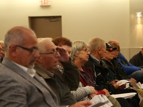 Jason Miller/The Intelligencer
Mayor Taso Christopher (first left) and former city councillor George Beer listen to a presentation on police area rating during a meeting at the Thurlow Community Centre.