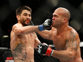 Robbie Lawler, right, trades blows with Carlos Condit during a welterweight championship mixed martial arts bout at UFC 195, Saturday, Jan. 2, 2016, in Las Vegas. (AP Photo/John Locher)