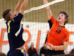 Strathroy's Ryan Grant tries to block a tip from Clarke Road's Gabe Walker during their afternoon match at Clarke Road on Wednesday October 11, 2017. The Trojans won the match 25-13, 25-14, and 25-23. (MIKE HENSEN, The London Free Press)