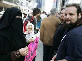 Zaynab Khadr, left, and her former husband Joshua Boyle protest in front of the Metro Convention centre in Toronto on Friday May 29, 2009. JIM ROSS / THE CANADIAN PRESS