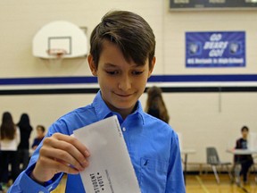 Sam Malick, 13, puts his ballot in the box during a mock municipal election at H.E. Beriault Junior High School in Edmonton on Thursday October 12, 2017. The Edmonton municipal election will be held on Monday October 16, 2017. LARRY WONG/POSTMEDIA