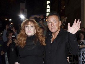 Bruce Springsteen and his wife Patti Scialfa exit out the stage door after the "Springsteen On Broadway" opening night performance at the Walter Kerr Theatre in New York on Thursday, Oct. 12, 2017. (Evan Agostini/Invision/AP)