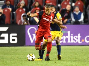 Toronto FC's Justin Morrow, left, takes possession of the ball in front of New York Red Bulls' Tyler Adams during first half MLS soccer action Saturday September 30, 2017 in Toronto. THE CANADIAN PRESS/Jon Blacker