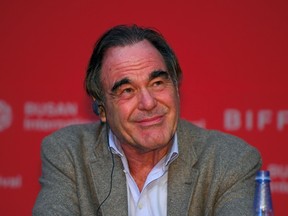 US director Oliver Stone smiles during a press conference of the New Currents Jury for the 22nd Busan International Film Festival (BIFF) at the Busan Cinema Center in Busan on October 13, 2017.
Oscar-winning director Oliver Stone on October 13 said disgraced movie mogul Harvey Weinstein was being "condemned by a vigilante system" as people rush to pass jugdement on allegations he sexually abused and raped multiple women. / AFP PHOTO / JUNG Yeon-JeJUNG YEON-JE/AFP/Getty Images