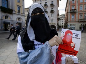 Islamic Central Council of Switzerland member Nora Illi poses on September 18, 2013 while distributing flyers in Lugano against an upcoming cantonal vote on banning face-covering headgear in public places. (Fabrice Coffrini/Getty Images)