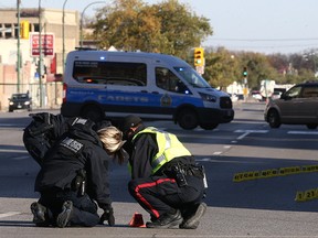 Police investigate at the scene of a fatal motor vehicle collision on Main Street near Sutherland Avenue in Winnipeg on Wed., Oct. 11, 2017. Const. Justin Holz, 34, was charged with impaired driving causing death after a pedestrian was struck and killed at the intersection on Oct. 10. Kevin King/Winnipeg Sun/Postmedia Network