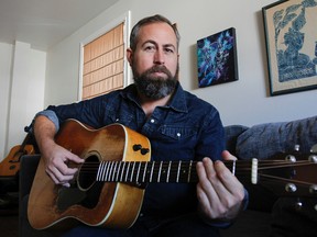 Local musician Tom Savage, seen here in his home on Thursday, Oct. 12, will be launching his newest album, Everything Intertwined at the Mansion at 8p.m. this Saturday. Julia McKay/The Whig-Standard/Postmedia Network