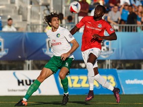 FC Edmonton's Tomi Ameobi (18) battles New York Cosmos' Dejan Jakovic (5) during a NASL game at Clarke Stadium in Edmonton on Friday, August 11, 2017.