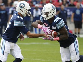 Toronto Argonauts Ricky Ray QB (15) hands off to  James Wilder Jr. RB (32)during the first half at BMO Field in Toronto, Ont. on Saturday October 7, 2017.
