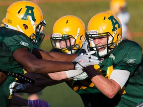 Shaydon Philip, left, and Ryan Migadel (24) take part in an Alberta Golden Bears football camp practice at Foote Field, in Edmonton on Monday Aug. 15, 2016.