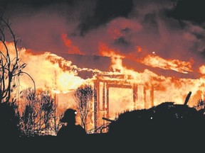 Firefighters assess the scene as a house burns in the Napa wine region of California earlier this week. Having a clearly defined escape plan in case of a fire can be a family lifesaver. (Getty Images)