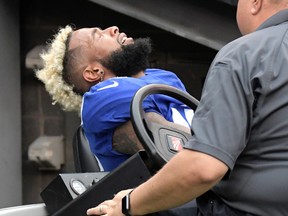In this Oct. 8, 2017, file photo, New York Giants wide receiver Odell Beckham reacts while being carted off the field after an injury during the second half of an NFL football game against the Los Angeles Chargers, in East Rutherford, N.J. (AP Photo/Bill Kostroun, File)