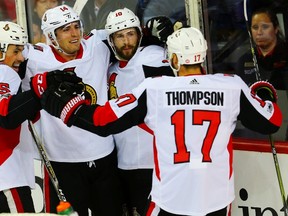Ottawa's Cody Ceci (left) celebrates his goal with teammates in the Sens' 6-0 win over the Flames in Calgary on Friday. (Al Charest/Postmedia Network)