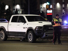 Edmonton Police Service officers investigate a collision between a truck and a pedestrian at 178 Street and 100 Avenue on Friday, October 14, 2017. Photo By David Bloom/Postmedia