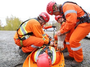 Gino Donato/Sudbury Star/Postmedia Network
NATT Safety Services Training Center held its grand opening at 98 Fielding Rd. in Sudbury on Friday. NATT Safety Services provides confined-space training for shutdowns within the mining, paper and forestry industries. Its customers include Vale, Glencore and Domtar. Demonstrating a rescue extraction in the confined space simulator are rescuers Sue Pelletier, Tom Spencer, Joel Merits, Natasha Ayles and Cameron Devlaminck.