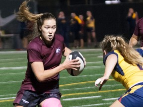 Belleville native and McMaster Marauders flanker Katie Svoboda takes on a Queen's University defender during OUA women's rugby semi-final action Friday night in Hamilton. (McMaster Athletics photo)