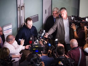 Joshua Boyle is photographed from above while he speaks to press after arriving at Lester B. Pearson Airport in Toronto on Friday, October 13, 2017. Boyle, His wife and and three children were held hostage for five years in Afghanistan. (THE CANADIAN PRESS/Christopher Katsarov)