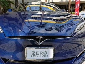 This Oct. 24, 2016, file photo shows Tesla Model S on display in downtown Los Angeles. Tesla Motors fired hundreds of workers after completing its annual performance reviews, even though the electric automaker is trying to ramp up production to meet the demand for its new Model 3 sedan. The Palo Alto, California-based company confirmed the cuts in a Saturday, Oct. 14, 2017 statement, but didn't disclose how many of its 33,000 workers were jettisoned. (AP Photo/Richard Vogel, File)