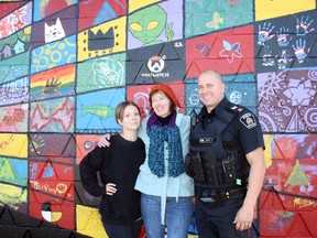Kathleen Ransom and Alexandra Dean from Myths and Mirrors and Jason Gagne, an acting sergeant with the Greater Sudbury Police, pose alongside a new mural at 2361 Bancroft Dr. in Sudbury. Ben Leeson/The Sudbury Star/Postmedia Network
