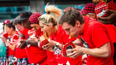 Carmen Cincotti, from Mays Landing, New Jersey, (right) took 1st place in the 8th Annual Smoke�s Poutinerie World Poutine Eating Championship held at Yonge-Dundas Square in downtown Toronto, Ont.  on Saturday October 14, 2017. Ernest Doroszuk/Toronto Sun/Postmedia Network