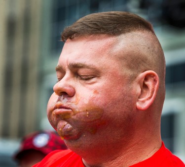 Jim Reeves pauses between bites at the 8th Annual Smoke�s Poutinerie World Poutine Eating Championship held at Yonge-Dundas Square in downtown Toronto, Ont.  on Saturday October 14, 2017. Ernest Doroszuk/Toronto Sun/Postmedia Network