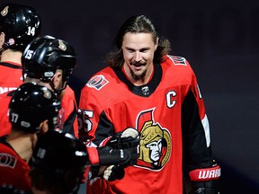Injured Ottawa Senators defenceman Erik Karlsson bumps gloves with teammates during player introductions prior to NHL hockey action against the Washington Capitals in Ottawa on Thursday, Oct. 5, 2017. THE CANADIAN PRESS/Adrian Wyld