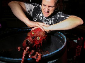 Brian P. Rowe of fx company, Locked in the Cellar Creations, poses with the 'zombie zen fountain' the Hamilton-based business brought with them to the Quinte Horror Expo at the Travelodge on Saturday October 14, 2017 in Belleville, Ont. Tim Miller/Belleville Intelligencer/Postmedia Network