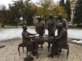 Snow covers the Famous Five monument on the grounds of the Manitoba Legislature in Winnipeg on Saturday, Oct. 14, 2017. Winnipeggers awoke Saturday morning to snow on the ground, an early preview of winter. GLEN DAWKINS/Winnipeg Sun/Postmedia Network