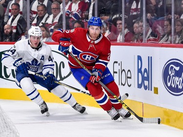 MONTREAL, QC - OCTOBER 14:  Karl Alzner #22 of the Montreal Canadiens skates the puck against Morgan Rielly #44 of the Toronto Maple Leafs during the NHL game at the Bell Centre on October 14, 2017 in Montreal, Quebec, Canada.  The Toronto Maple Leafs defeated the Montreal Canadiens 4-3 in overtime.  (Photo by Minas Panagiotakis/Getty Images)