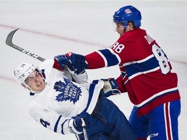 Montreal Canadiens' Brandon Davidson (88) collides with Toronto Maple Leafs' Auston Matthews during first period NHL hockey action in Montreal, Saturday, October 14, 2017. THE CANADIAN PRESS/Graham Hughes ORG XMIT: GMH103