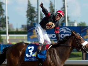 Jockey Luis Contreras celebrates after guiding Holy Helena to victory in the Queen’s Plate at Woodbine on July 2, 2017. Contreras will be back on Holy Helena on Oct. 15, 2017, in the Grade 3 Ontario Derby, although he could have ridden Cool Catomine. (WEG/MICHAEL BURNS/File photo)