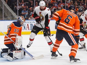 Ottawa Senators' Zack Smith (15) tries to tip the puck past Edmonton Oilers goalie Cam Talbot (33) as Adam Larsson (6) defends during first period NHL hockey action in Edmonton on Saturday, October 14, 2017.