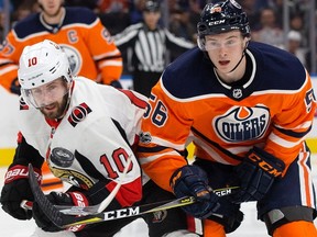 The Edmonton Oilers Kailer Yamamoto (56) battles the Ottawa Senators' Tom Pyatt (10) during second period NHL action at Rogers Place on Saturday, Oct. 14, 2017.