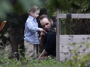 Joshua Boyle and his son Jonah play in the garden at his parents house in Smiths Falls, Ont., on Saturday, Oct. 14, 2017. THE CANADIAN PRESS/Lars Hagberg