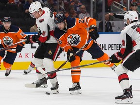 The Edmonton Oilers Iiro Pakarinen (26) battles the Ottawa Senators' Dion Phaneuf (2) during third period NHL action at Rogers Place on Saturday, Oct. 14, 2017. Photo by David Bloom