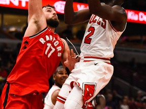 Chicago Bulls guard Jerian Grant (2) drives to the basket while being defended by Toronto Raptors center Jonas Valanciunas (17) during the second half of an NBA preseason basketball game Friday, Oct. 13, 2017, in Chicago. (AP Photo/Matt Marton)
