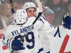 Toronto Maple Leafs' Auston Matthews (34) celebrates with teammate William Nylander after scoring during overtime NHL hockey action against the Montreal Canadiens, in Montreal, Saturday, October 14, 2017. (THE CANADIAN PRESS/Graham Hughes)