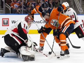 The Edmonton Oilers Kailer Yamamoto (56) and Kris Russell (4) are stopped by the Ottawa Senators' goalie Mike Condon (1) during first period NHL action at Rogers Place on Saturday, Oct. 14, 2017.