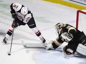 William Sirman of the Windsor Spitfires gets in close on Sarnia Sting goalie Aidan Hughes on Sunday, Oct. 15, 2017, at the WFCU Centre in Windsor, Ont. (DAN JANISSE/Postmedia Network)