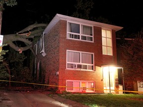 A tree felled by high winds rests on the roof of a triplex on Balsam Ave. south of Queen St. E., on Sunday, Oct. 15, 2017. (John Hanley/Special to the Toronto Sun)
