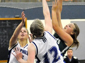 Elaine White (32) and Erica Babb of the Mitchell District High School (MDHS) senior girls basketball team epitomized tight defence in their narrow 27-26 win over Kincardine during action from the 13-team St. Michael tournament last Friday, Oct. 13 in Mitchell. ANDY BADER/MITCHELL ADVOCATE