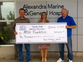 Mike Cleminson (L) and Steve Piper (R), representing the Power Workers’ Union, present Shannon LaHay, Foundation Coordinator, with a $10,000 donation.