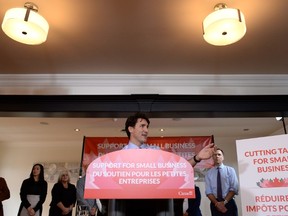 Prime Minister Justin Trudeau speaks to members of the media as Finance Minister Bill Morneau looks on at a press conference on tax reforms in Stouffville, Ont., on Monday, October 16, 2017. THE CANADIAN PRESS/Nathan Denette