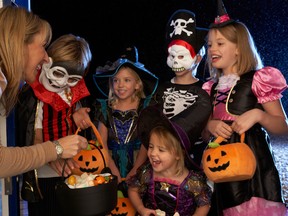 In this stock photo, children trick or treat while dressed up in costumes on Halloween. (Getty Images)