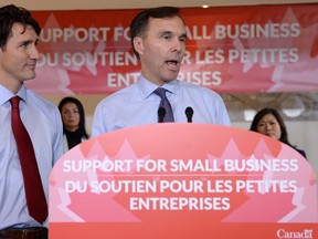 Finance Minister Bill Morneau (right) speaks to members of the media as Prime Minister Justin Trudeau looks on at a press conference on tax reforms in Stouffville, Ont., on Monday, Oct. 16, 2017. (Nathan Denette/The Canadian Press)