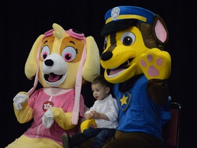 Maddox Mills, 2, sits with characters from "Paw Patrol" during the Bump, Baby and Beyond Expo on Oct. 14.