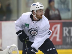 Kyle Connor sets up shop in front of goaltender Connor Hellebuyck during Winnipeg Jets practice at MTS Iceplex in Winnipeg on Mon., Oct. 16, 2017. Kevin King/Winnipeg Sun/Postmedia Network