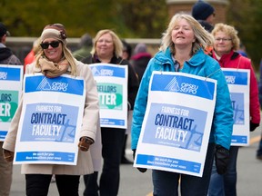 Jennifer Rishor, left, and Angela Pind, members of Ontario Public Service Employees Union (OPSEU) Local 352, picket at Fleming's Sutherland Campus during a faculty strike on Monday, October 16, 2017. JESSICA NYZNIK/Peterborough Examiner file photo