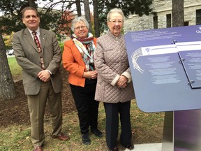 Queen's University principal Daniel Woolf, Janice Hill, director of Indigenous Initiatives at Queen's, and Dr. Marlene Brant Castellano, co-chair of the Aboriginal Council at Queen's, stand next to a newly unveiled plinth on the campus Monday. The plinth honours, among others, the Anishinaabe and the Haudenosaunee, on whose traditional lands the university was built. (Mike Norris/The Whig-Standard/Postmedia Network)