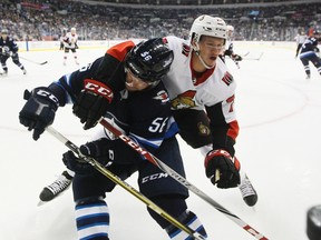 Ottawa Senators' Thomas Chabot checks Winnipeg Jets' Marko Dano during NHL pre-season action in Winnipeg on Sept. 27, 2017. (THE CANADIAN PRESS/John Woods)